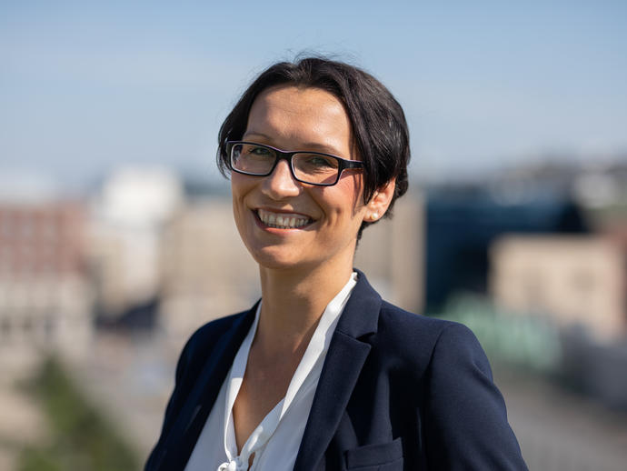 female employee in suit smiling
