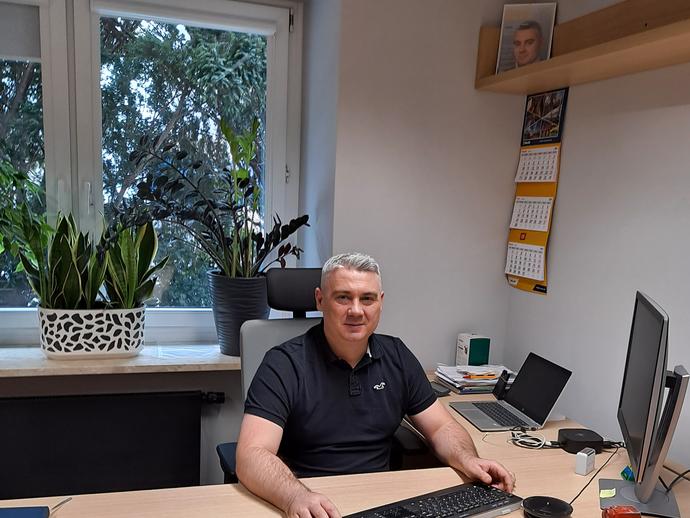 man smiling at desk