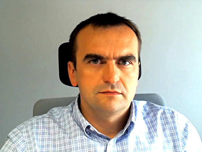 head shot of man sitting in office chair